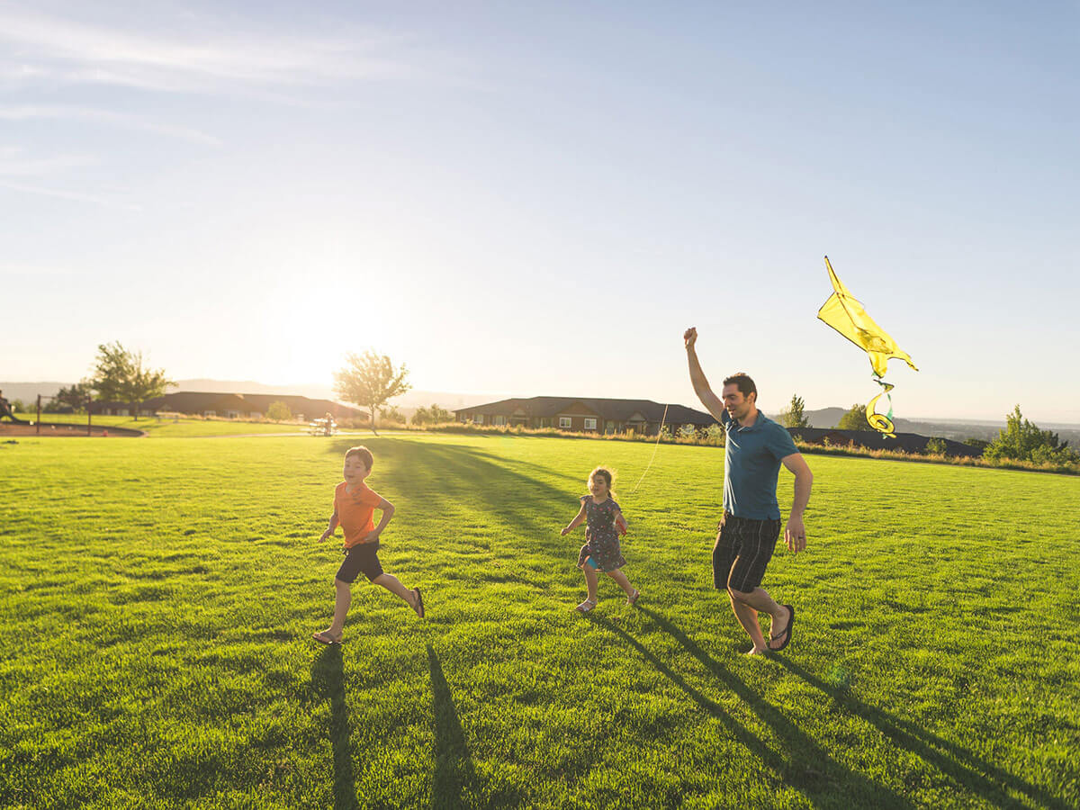 Family flying kite at park