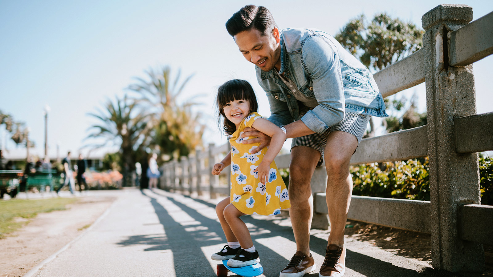 Dad and daughter skateboarding