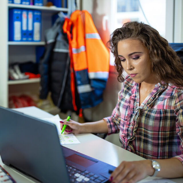 Woman Reviewing Permits At Desk